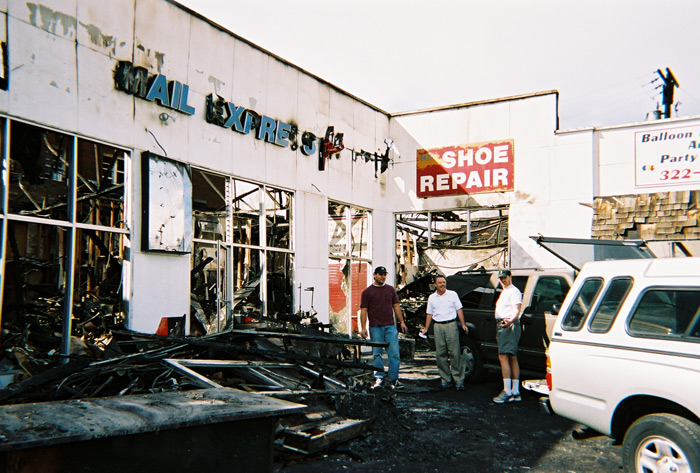 Dad in front of store after the fire 2003