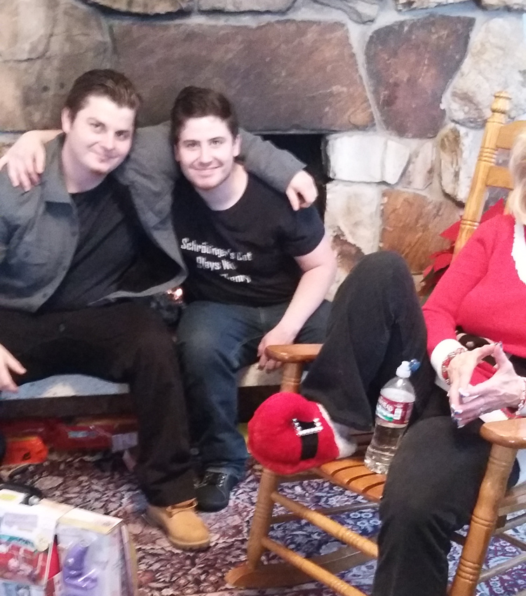 Mike in front of the home fireplace with Nick