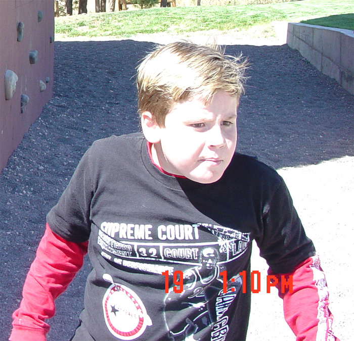 One of his funny faces in front of the Zion Pondersona rock wall. ~2006 